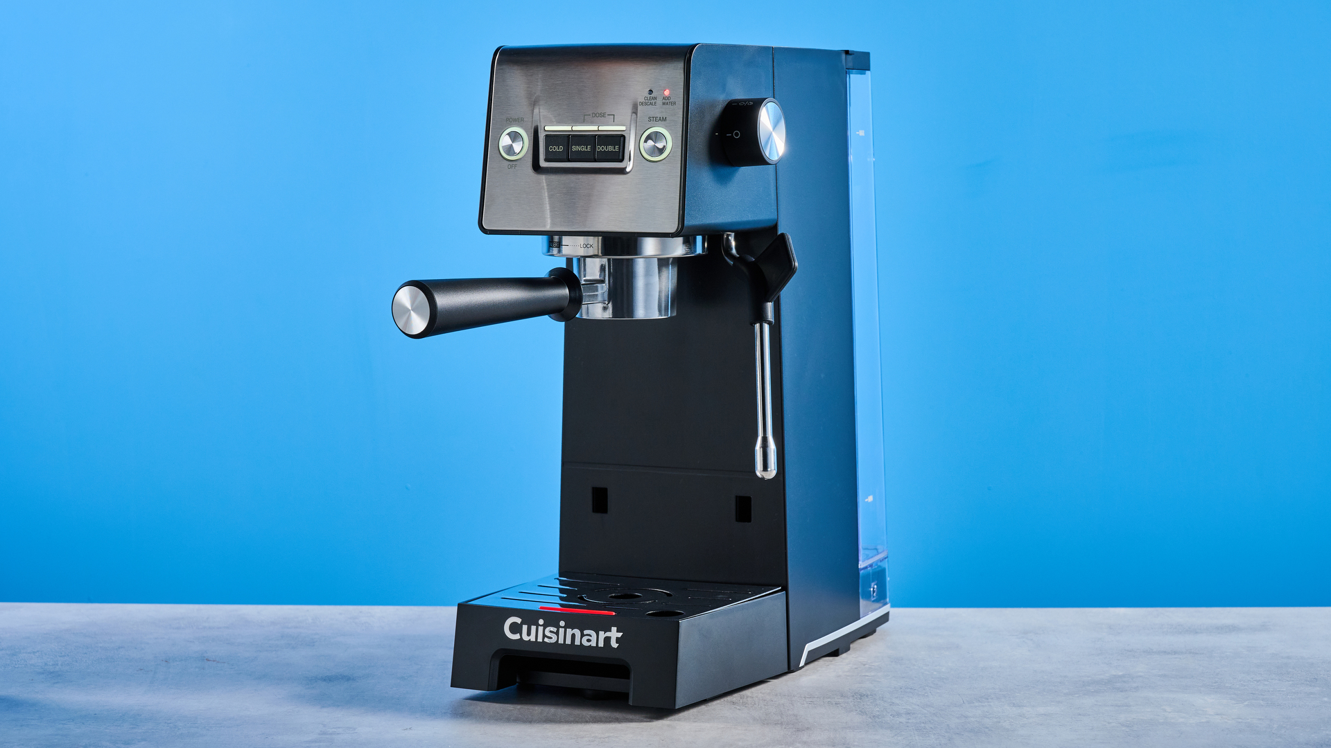 The Cuisinart Espresso Bar Slim espresso machine on a stone surface with a blue background