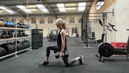Kerrie Hughes doing weighted lunges with dumbbells