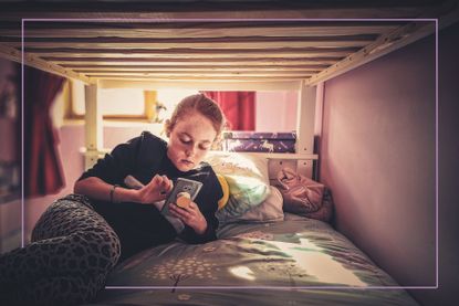 Tween lying on bed with smartphone