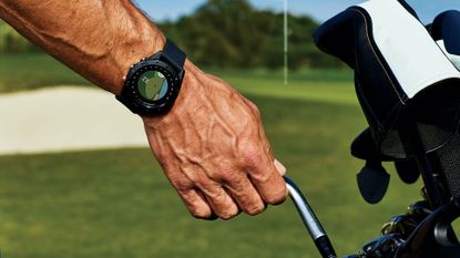 best golf watch: Pictured here, the hand of a golfer pulling out a club from the caddy