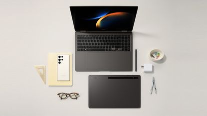 Samsung Galaxy Ecosystem 2023 on white surface, includes Galaxy S23 phone and Galaxy Book3 laptop