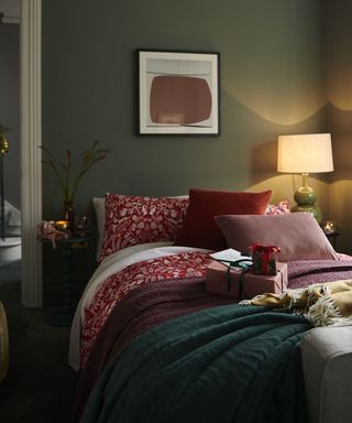 cosy bedroom with green walls and red festive bedding