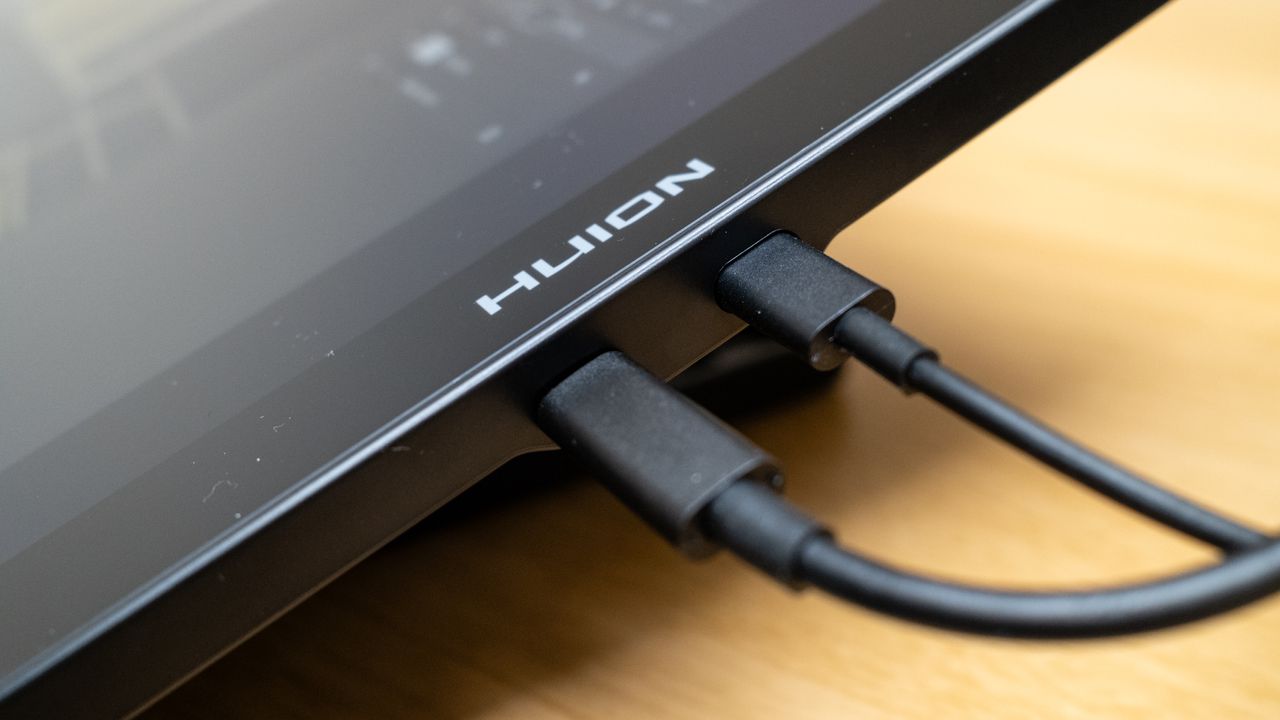 USB ports on a Huion Kamvas 16 (Gen 3) drawing tablet on a wooden desk
