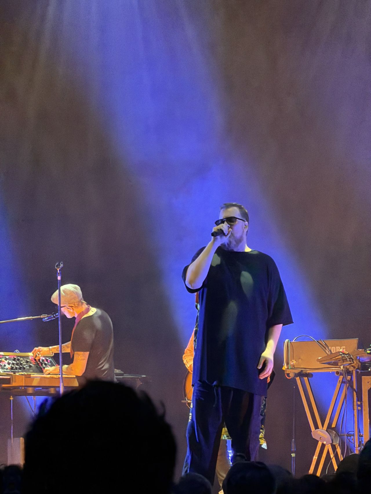 Sample photo from iPhone 17 Pro showing singer at a concert