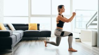 Woman performs lunge exercise in her home
