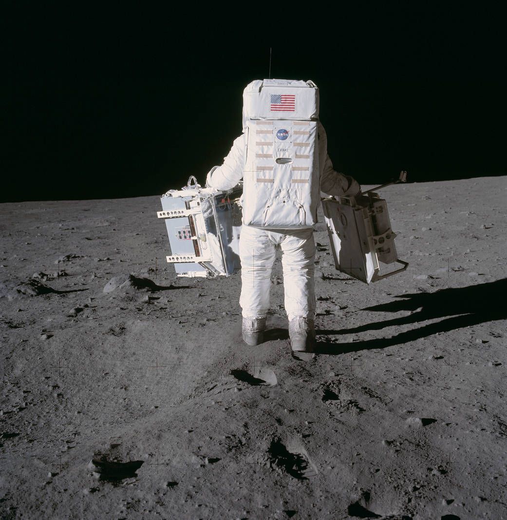 In this image taken during the Apollo 11 mission, astronaut Buzz Aldrin moves toward a position to deploy two components of the Early Apollo Scientific Experiments Package (EASEP) on the surface of the moon.