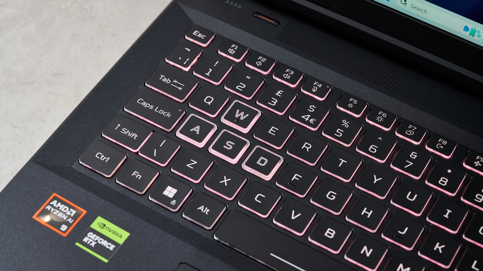 Close-up of WASD keys on Acer Nitro 18 AI with keyboard backlighting on