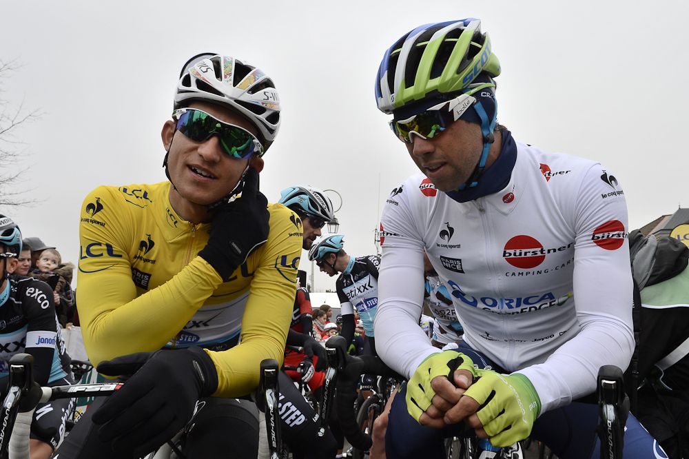 Poland's Michal Kwiatkowski (L) wearing the overall leader's yellow jersey speaks with Australia's Michael Matthews wearing the best young's white jersey as they wait for the start.