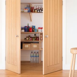 kitchen pantry with food items in wooden cupboard