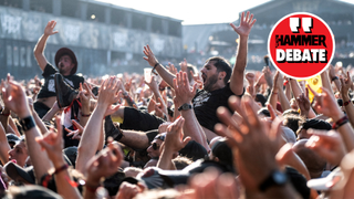 A man crowdsurfing over a crowd at a metal show
