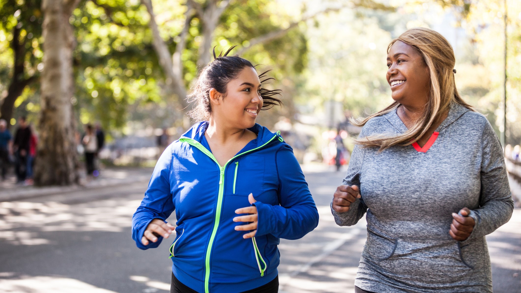 A photo of two women running together