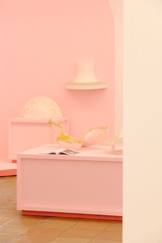 Design objects shown on a pink wall at Design Parade in Hyeres