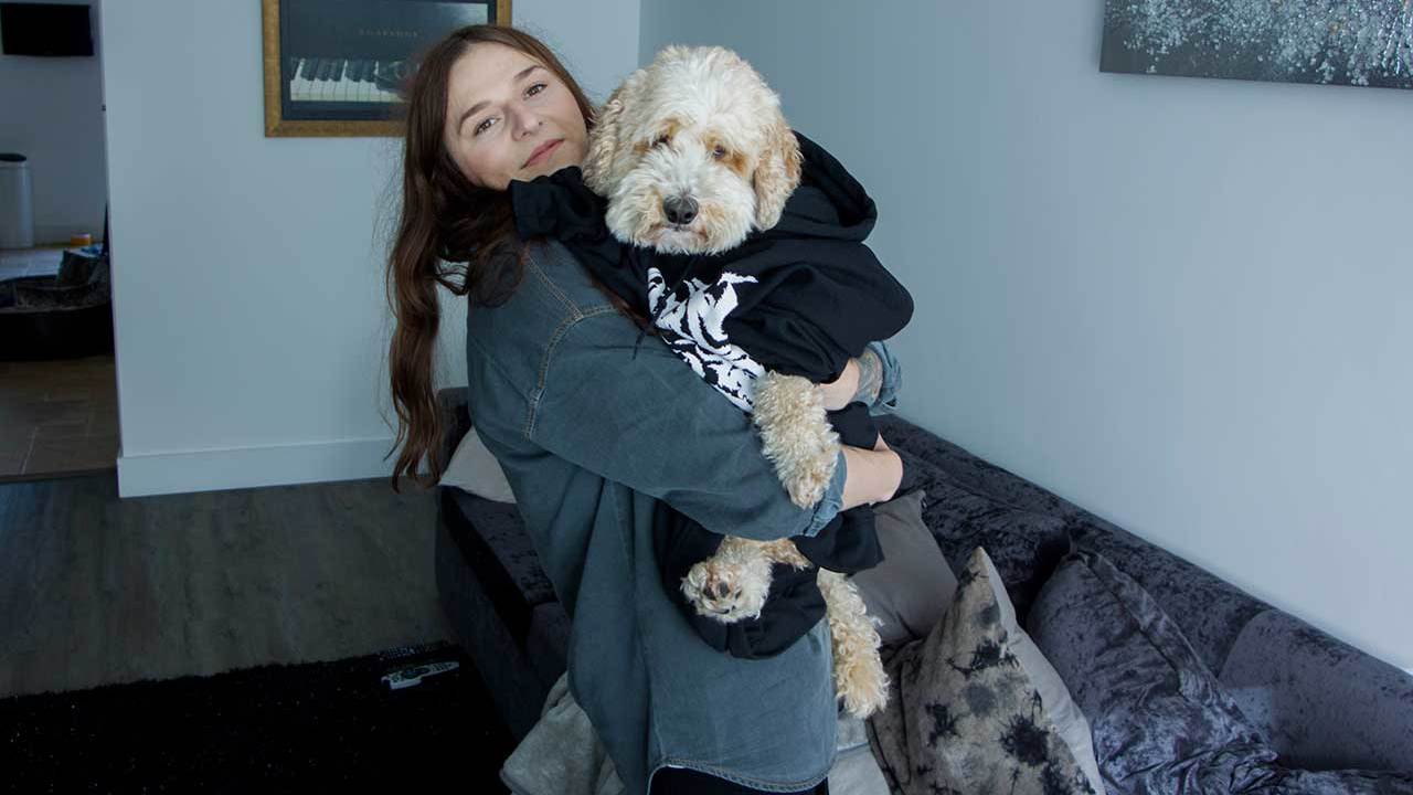 Venom Prison singer Larissa holding Barney the dog