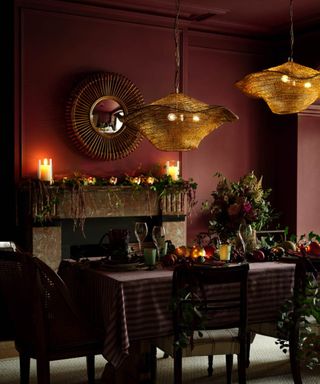 dining room with dark burgundy wall and cozy festive decor