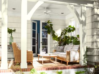 A porch painted in Benjamin Moore paint with surrounding foliage