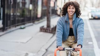 Woman cycling on street
