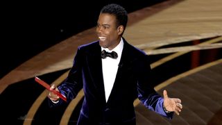 HOLLYWOOD, CALIFORNIA - MARCH 27: Chris Rock speaks onstage during the 94th Annual Academy Awards at Dolby Theatre on March 27, 2022 in Hollywood, California.