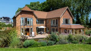 oak frame self build clad in brick and clay tiles with gable roof