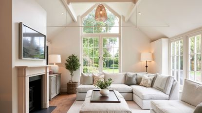 light living room with stone fireplace and cream sofas to support a guide on light colour temperature and how to use it