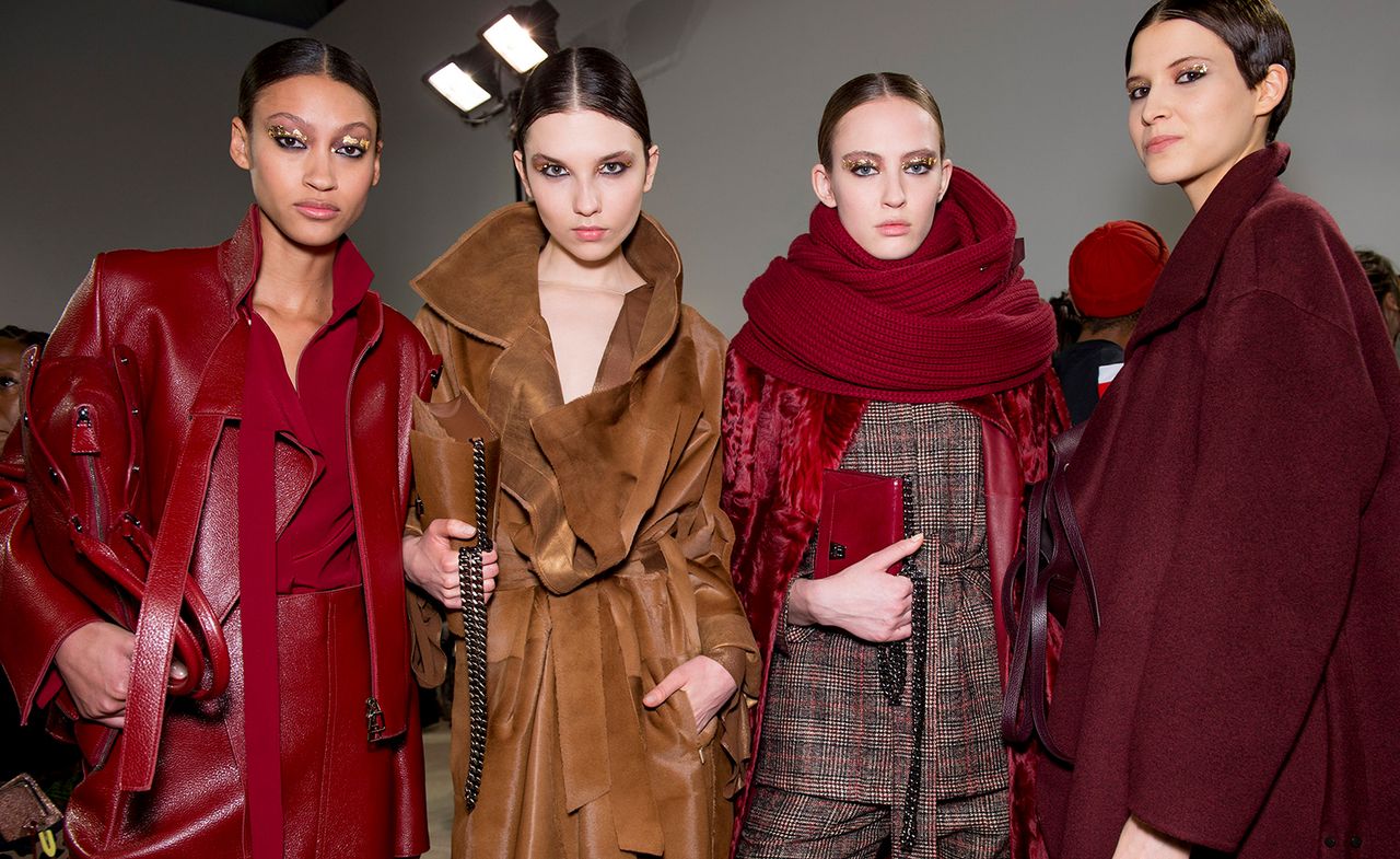 Models wear red leather, burgundy set and brown suede coat with matching handbags and oversized red scarf