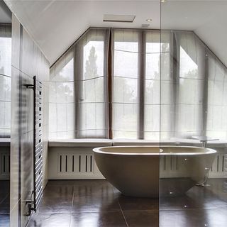 bathtub with tiles and glass door