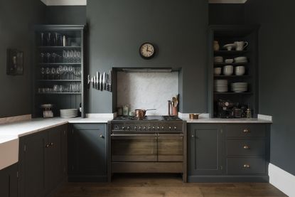 Devol ktichen with dark grey walls and dark grey cabinets