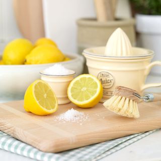 vinegar with lemons and wooden board