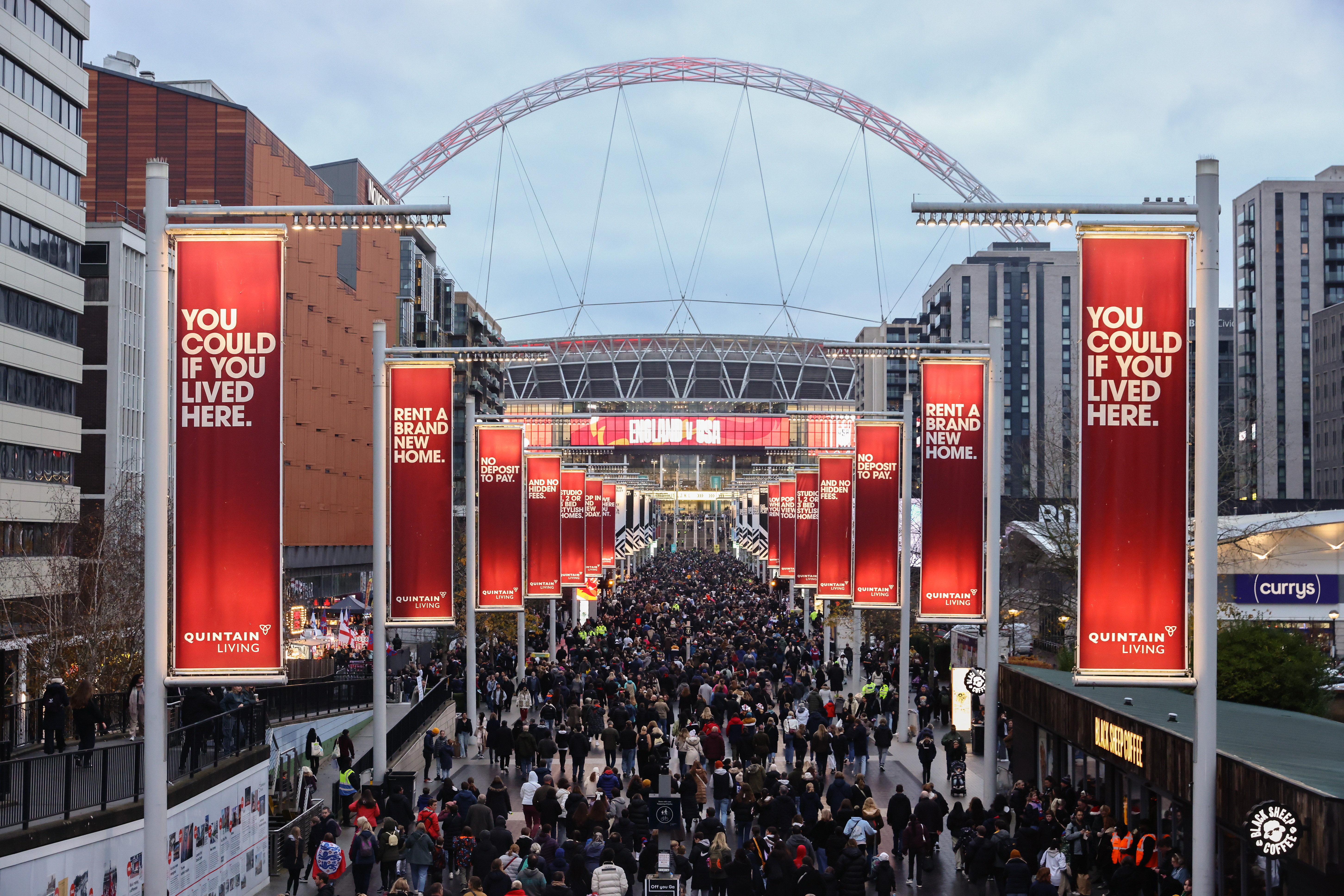 An image of the road leading up to Wembley Stadium, which is filled with people.