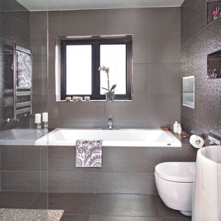 modern brown metallic bathroom built in bath integrated tv wall mounted towel rail