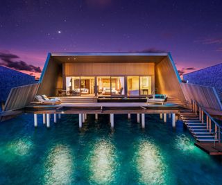 A shot of a Sunset Over Water Villa at St. Regis Maldives Vommuli Resort