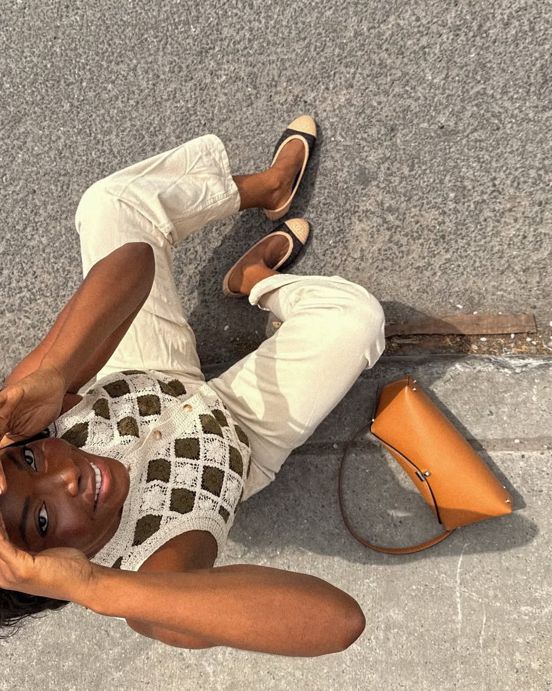 Influencer Coco Bassey wearing cream jeans and a crochet top.