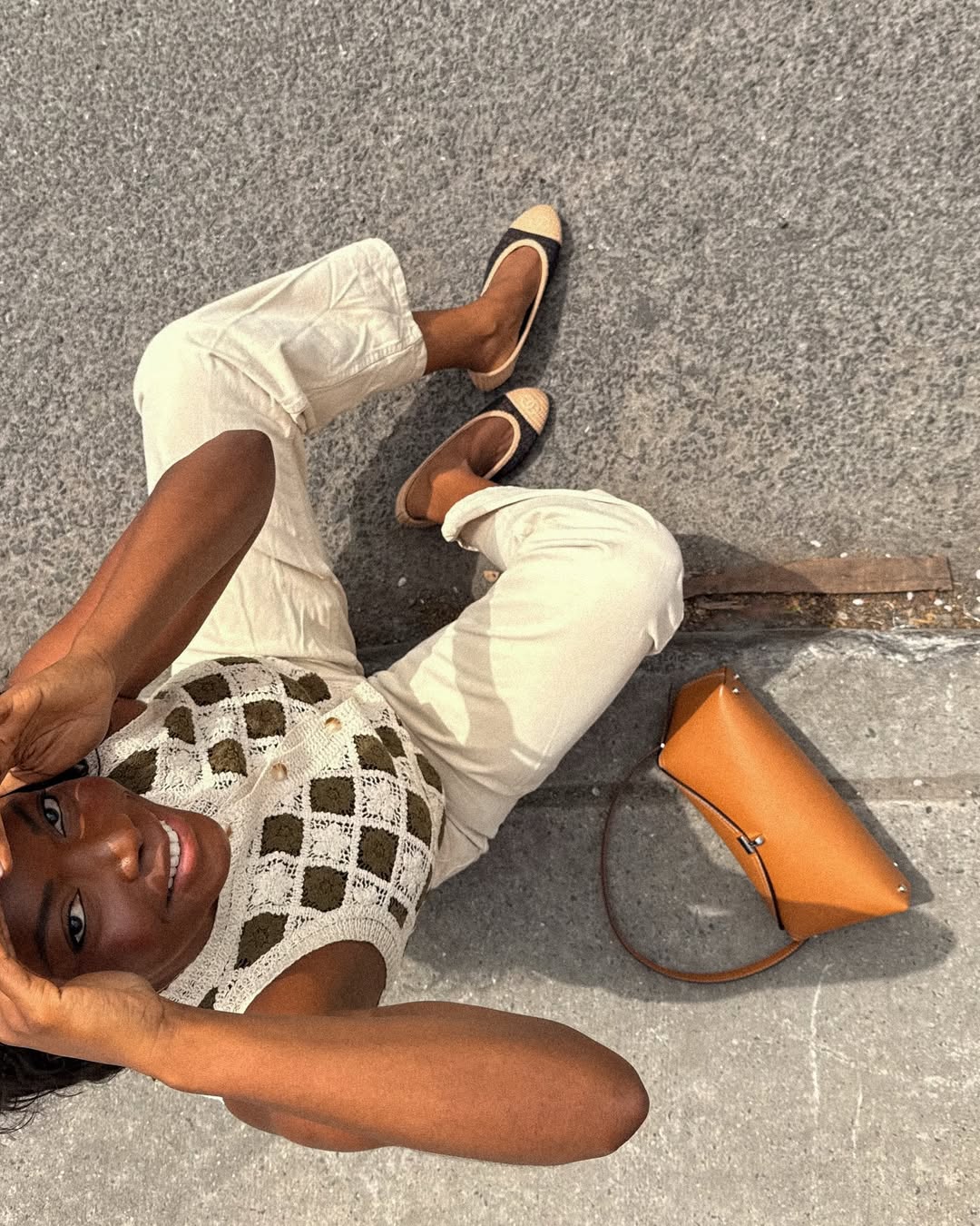 Influencer Coco Bassey wearing cream jeans and a crochet top.