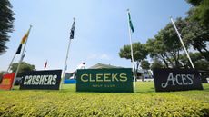 Boards on a putting green showing Crushers GC, Cleeks Golf Club and 4Aces GC logos