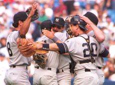 Don Mattingly (center) hugs his teammates after the New York Yankees beat the Toronto Blue Jays in the 1995 American League wild-card game. 