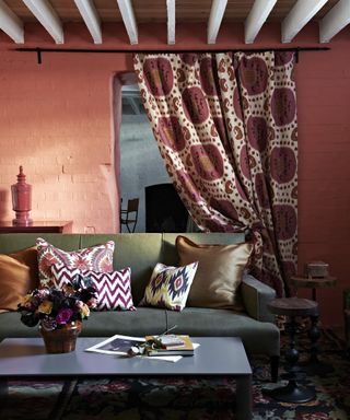 A living room curtain idea with red walls and internal curtain with pomegranate pattern