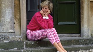 Diana, Princess Of Wales, sitting on the steps outside her country home at Highgrove.