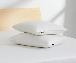 Two Brooklinen Down Pillows on a mattress.