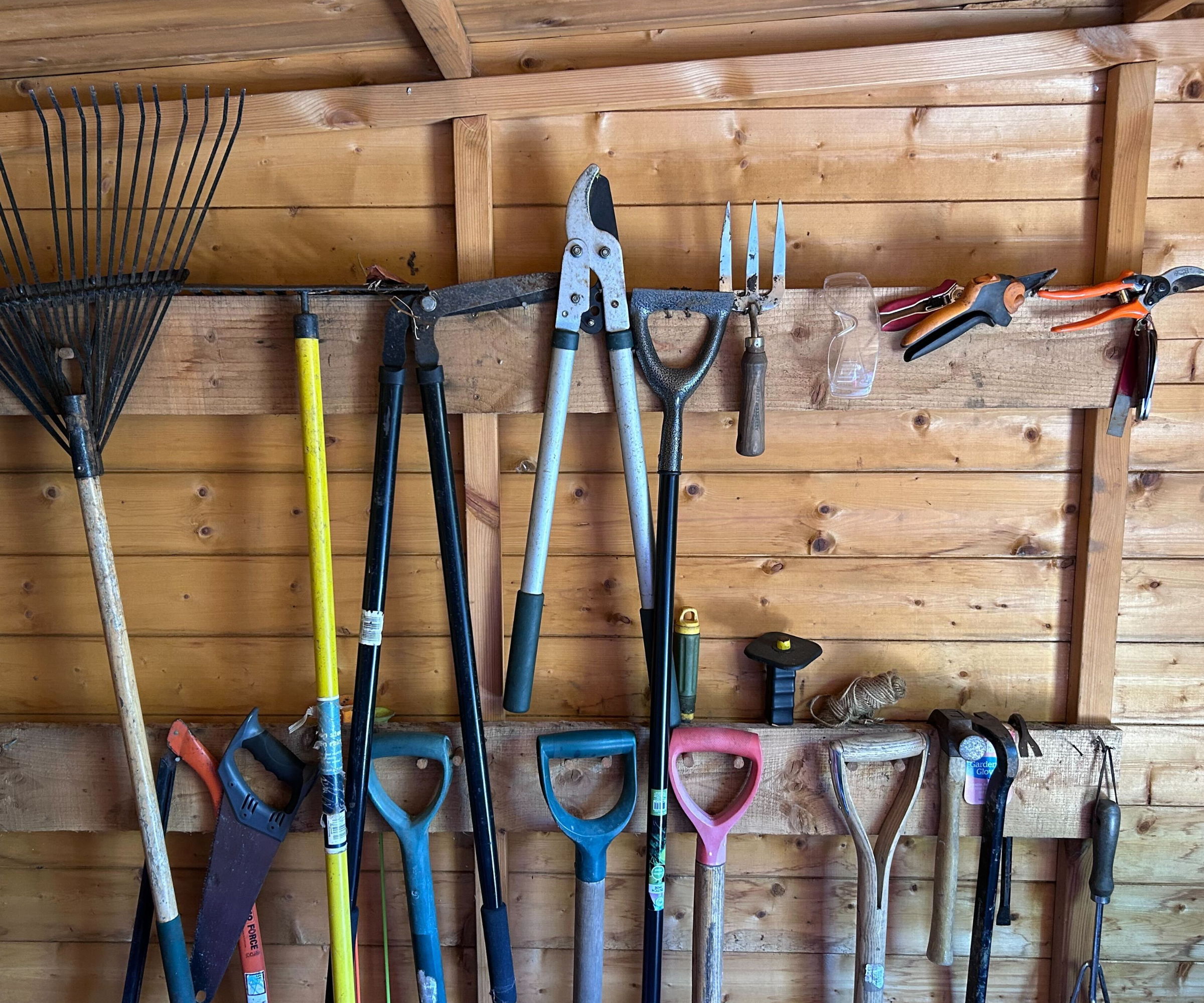 Garden tools hung up on pegs