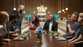 A contestant explains his dish to judges Crystelle Pereira and Atul Kochhar, who are sitting at a dining table in the studio with some of the other contestants