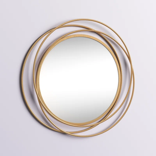 Accent mirror surrounded by gold metal