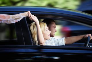 Couple riding in a car at high speed 
