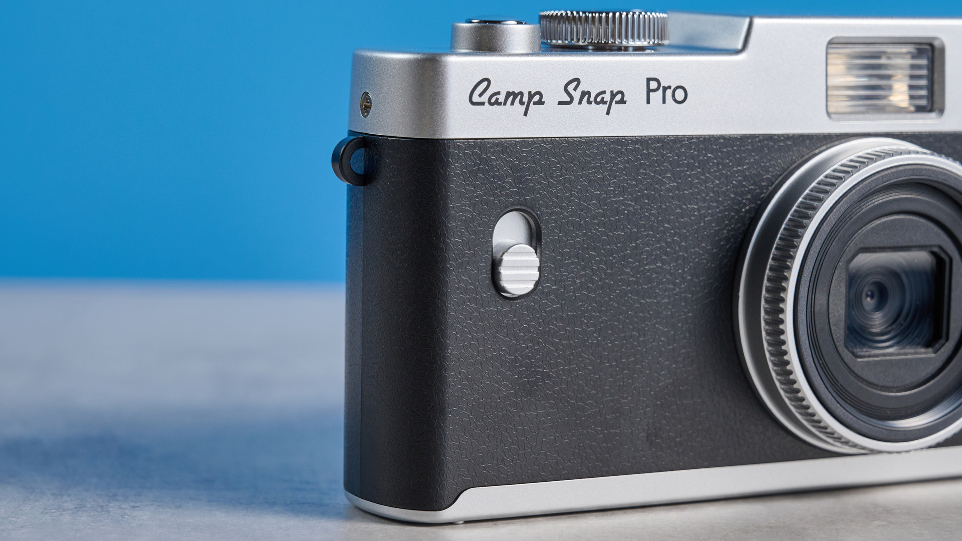 Camp Snap CS-Pro in black and silver photographed on a blue background