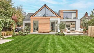 A modern detached home with a thick lawn in front