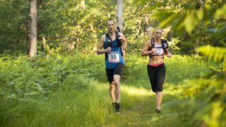 Man and woman trail running