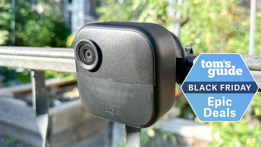 A Blink Outdoor camera mounted to an exterior railing with a Tom&#039;s Guide Black Friday deals badge