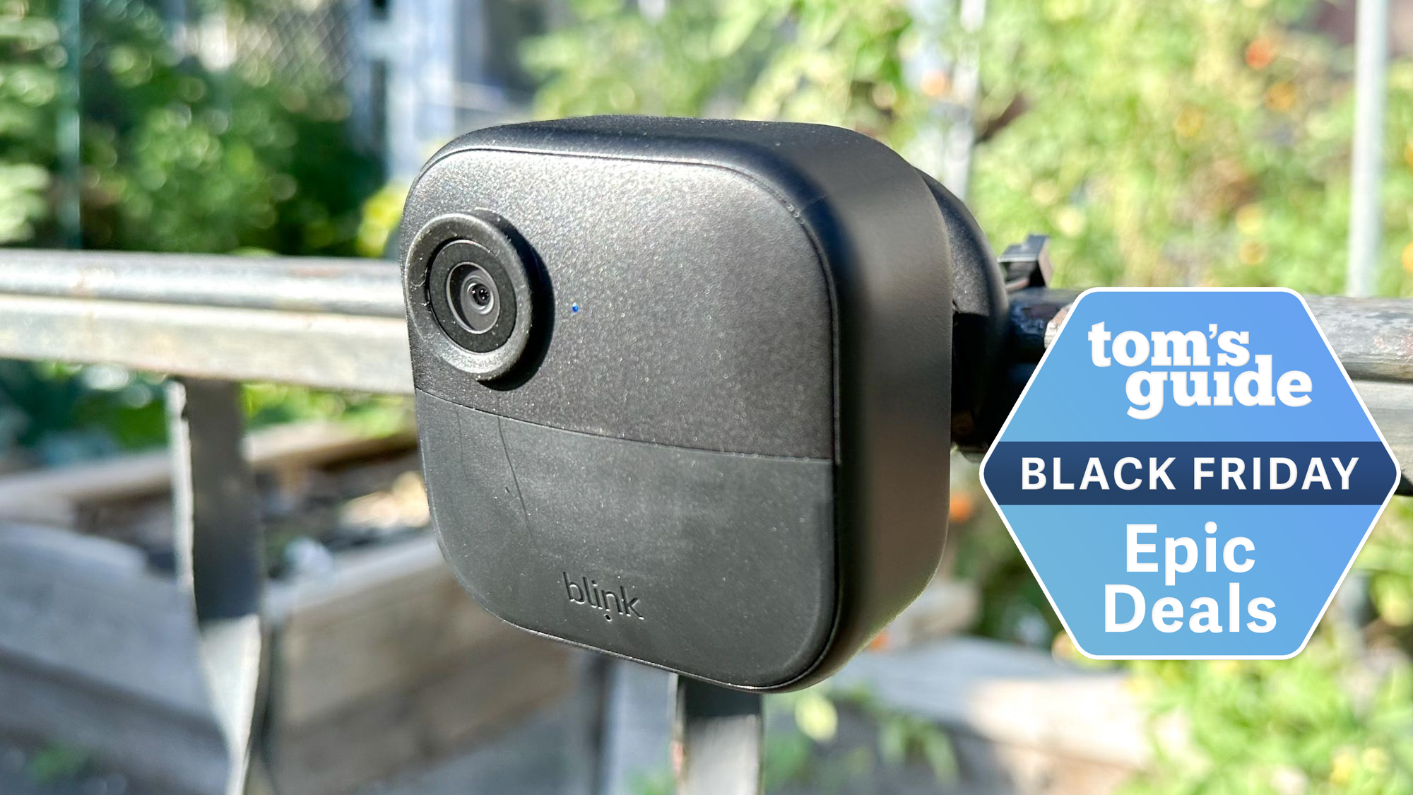 A Blink Outdoor camera mounted to an exterior railing with a Tom's Guide Black Friday deals badge