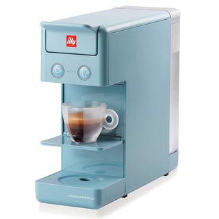 Blue Illy espresso maker with red label and with half-filled cup