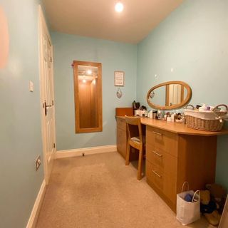dressing room with blue wall dressing table and mirror on wall