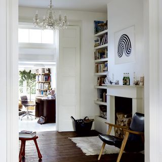 living room with white walls and wooden flooring