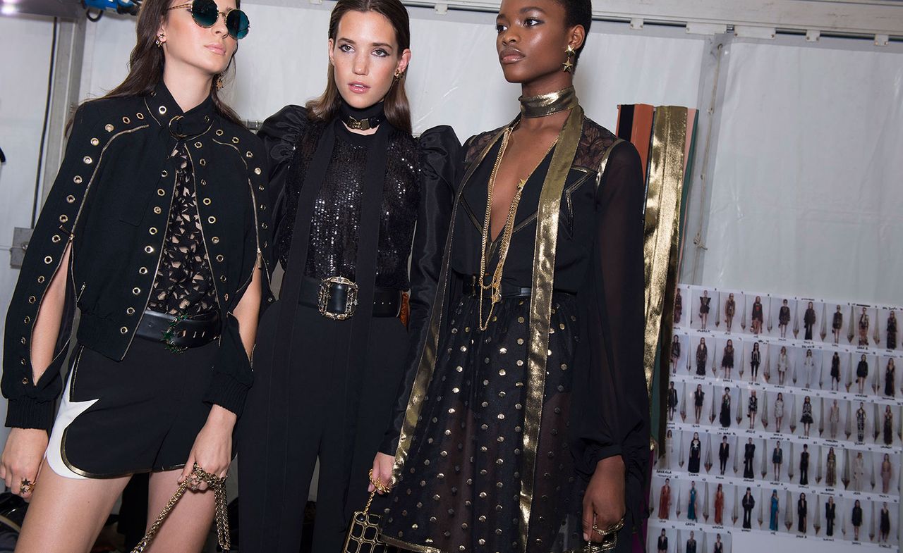 Three models giving pose in Black dress.